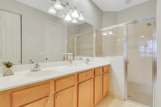 a bathroom with a double vanity sink and a mirror