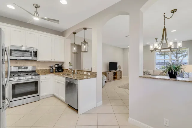 a kitchen with stainless steel appliances granite countertop a stove and cabinets