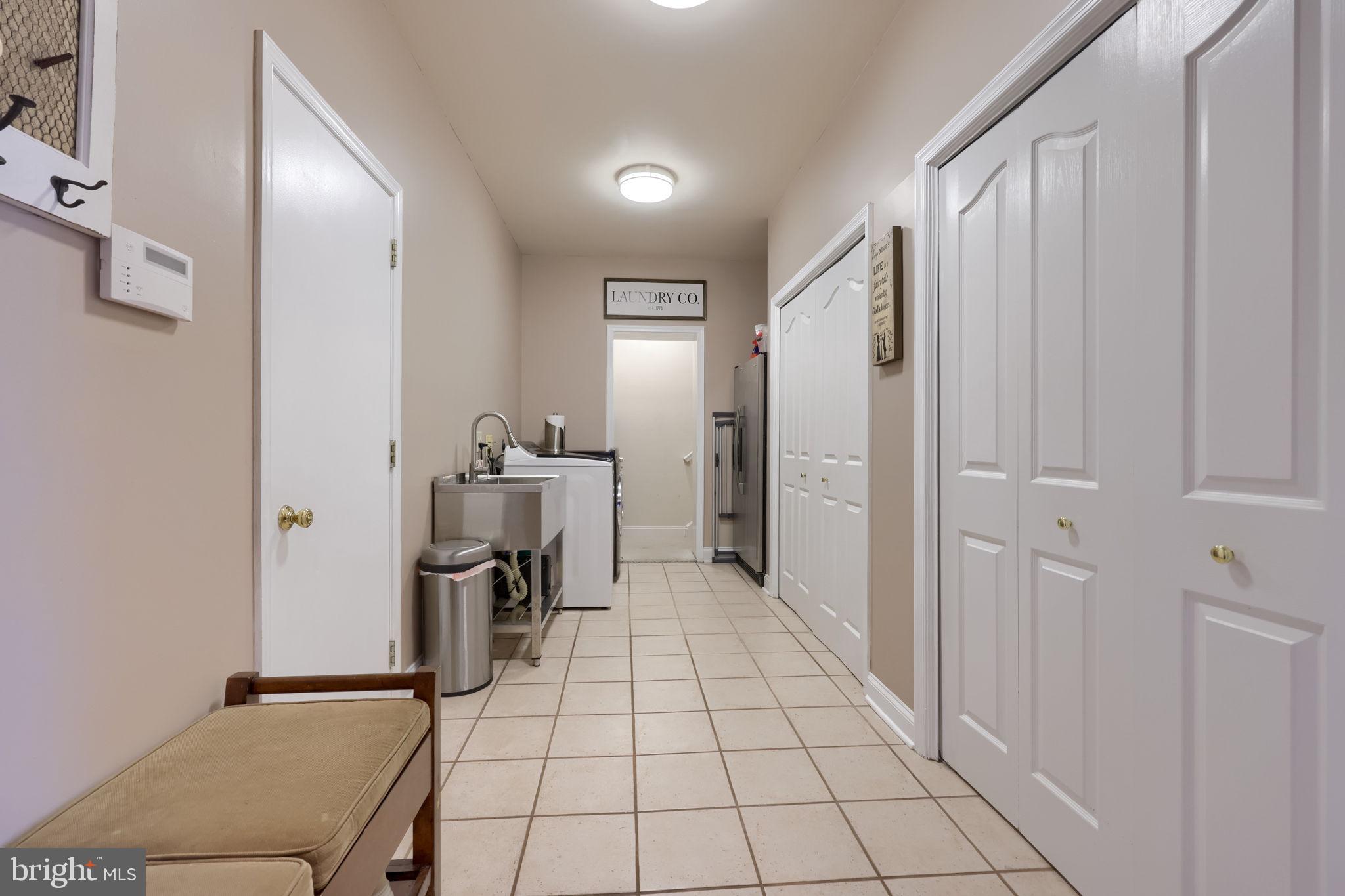 4972 Farmington Road Harrisburg, PA 17112 - Photo 15 of 57 a view of a hallway with furniture and a refrigerator