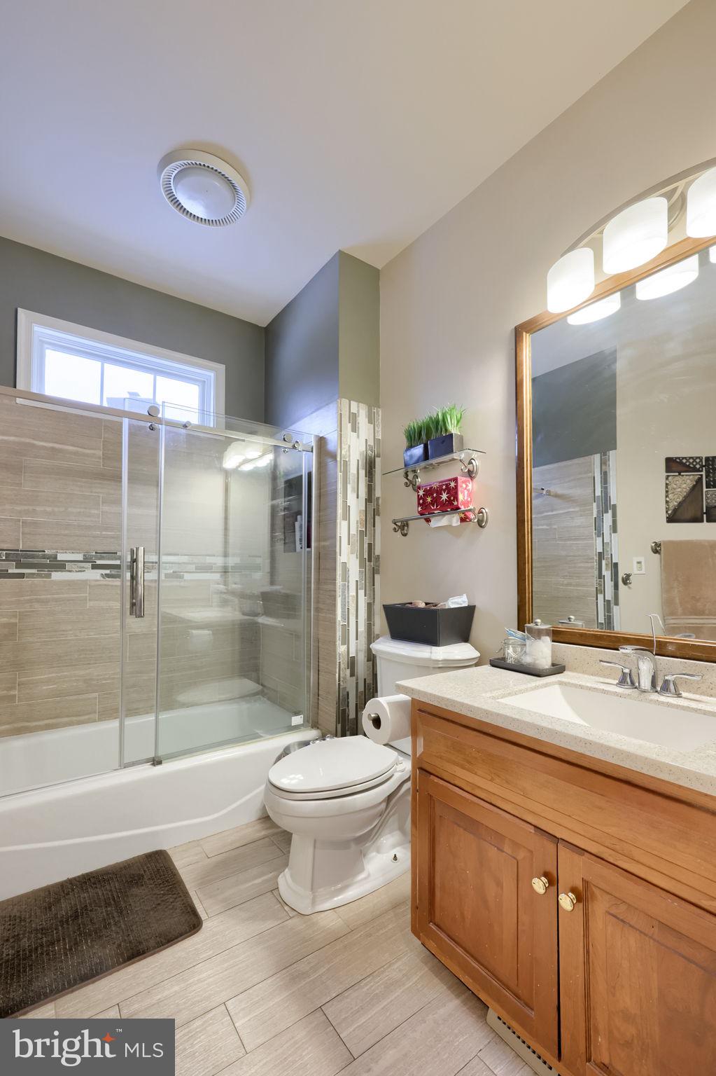 4972 Farmington Road Harrisburg, PA 17112 - Photo 16 of 57 a bathroom with a granite countertop sink toilet mirror and shower