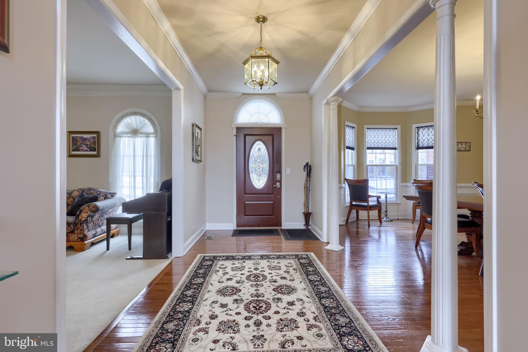 4972 Farmington Road Harrisburg, PA 17112 - Photo 3 of 57 a hallway with wooden floor chandelier and entryway