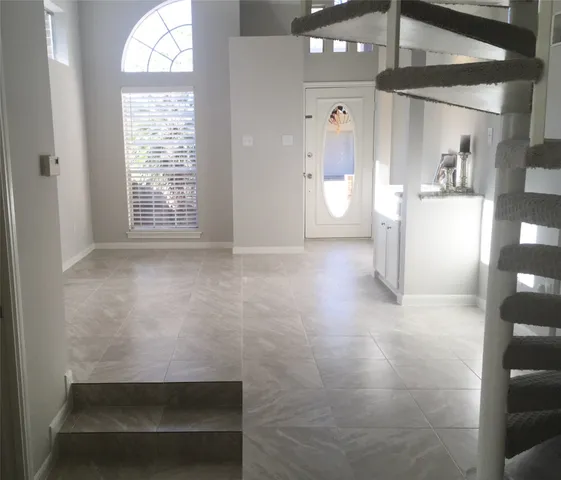 a kitchen with a sink a window and cabinets