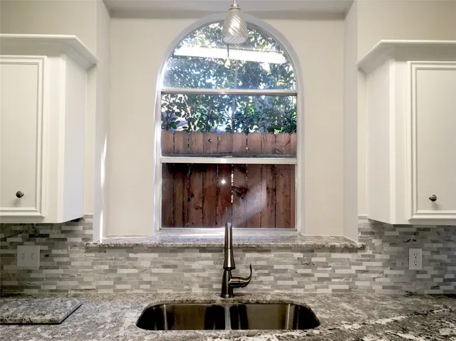 a kitchen with a sink and cabinets