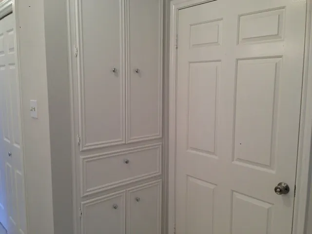 a city street lined with buildings and cars parked on the roadside