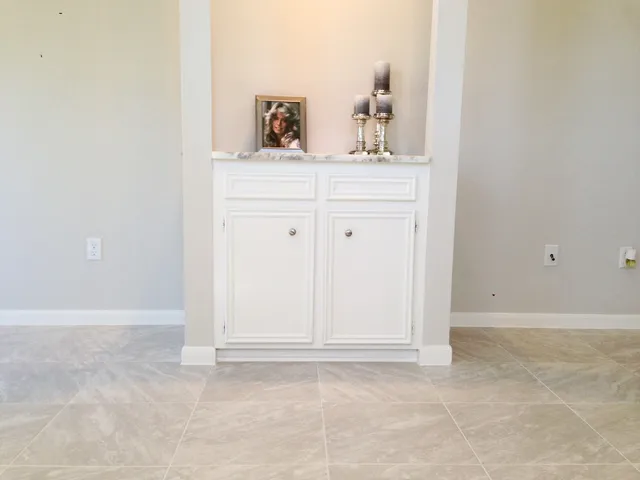 a view of kitchen with white cabinets