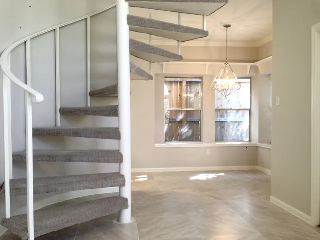 a view of a room with window and door