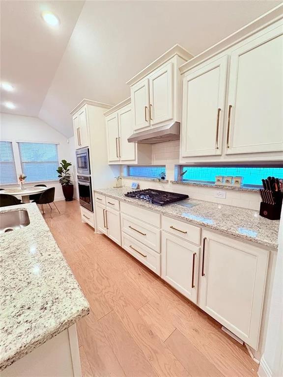 809 Elizabeth Street Anna, TX 75409 - Photo 11 of 13 a kitchen with granite countertop a sink stainless steel appliances and white cabinets