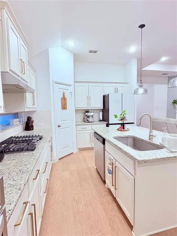 809 Elizabeth Street Anna, TX 75409 - Photo 10 of 13 a kitchen with stainless steel appliances granite countertop a sink stove and refrigerator