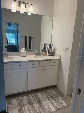 a bathroom with a sink a vanity and a mirror