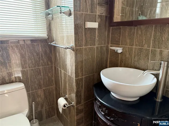 a bathroom with a toilet a sink and a mirror