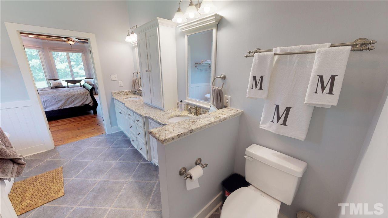 3509 Bahama Road Rougemont, NC 27572 - Photo 11 of 30 a bathroom with a sink a toilet a mirror and shower