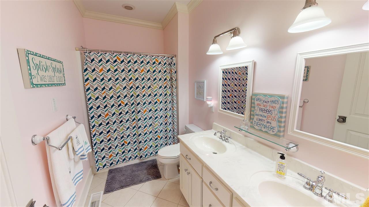 3509 Bahama Road Rougemont, NC 27572 - Photo 16 of 30 a bathroom with a sink a toilet and a mirror