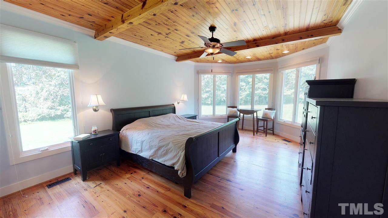 3509 Bahama Road Rougemont, NC 27572 - Photo 9 of 30 a spacious bedroom with a bed and a chandelier