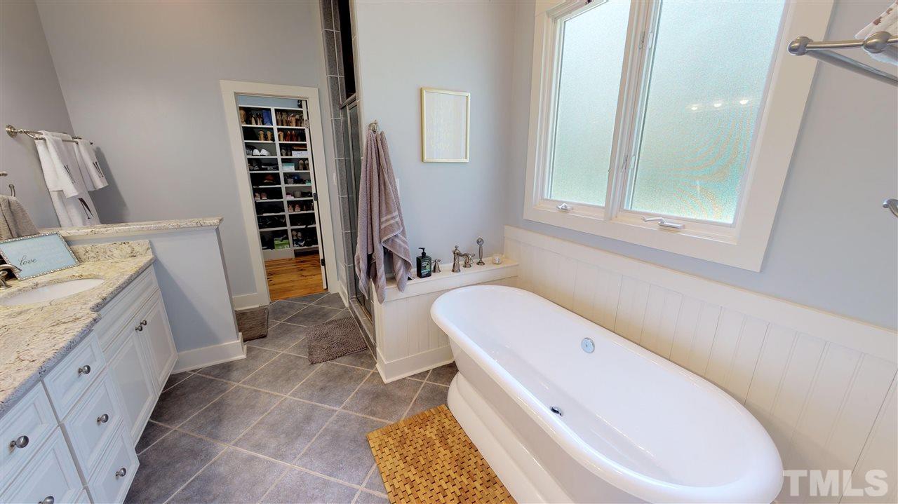 3509 Bahama Road Rougemont, NC 27572 - Photo 10 of 30 a bathroom with a tub a sink and a large mirror