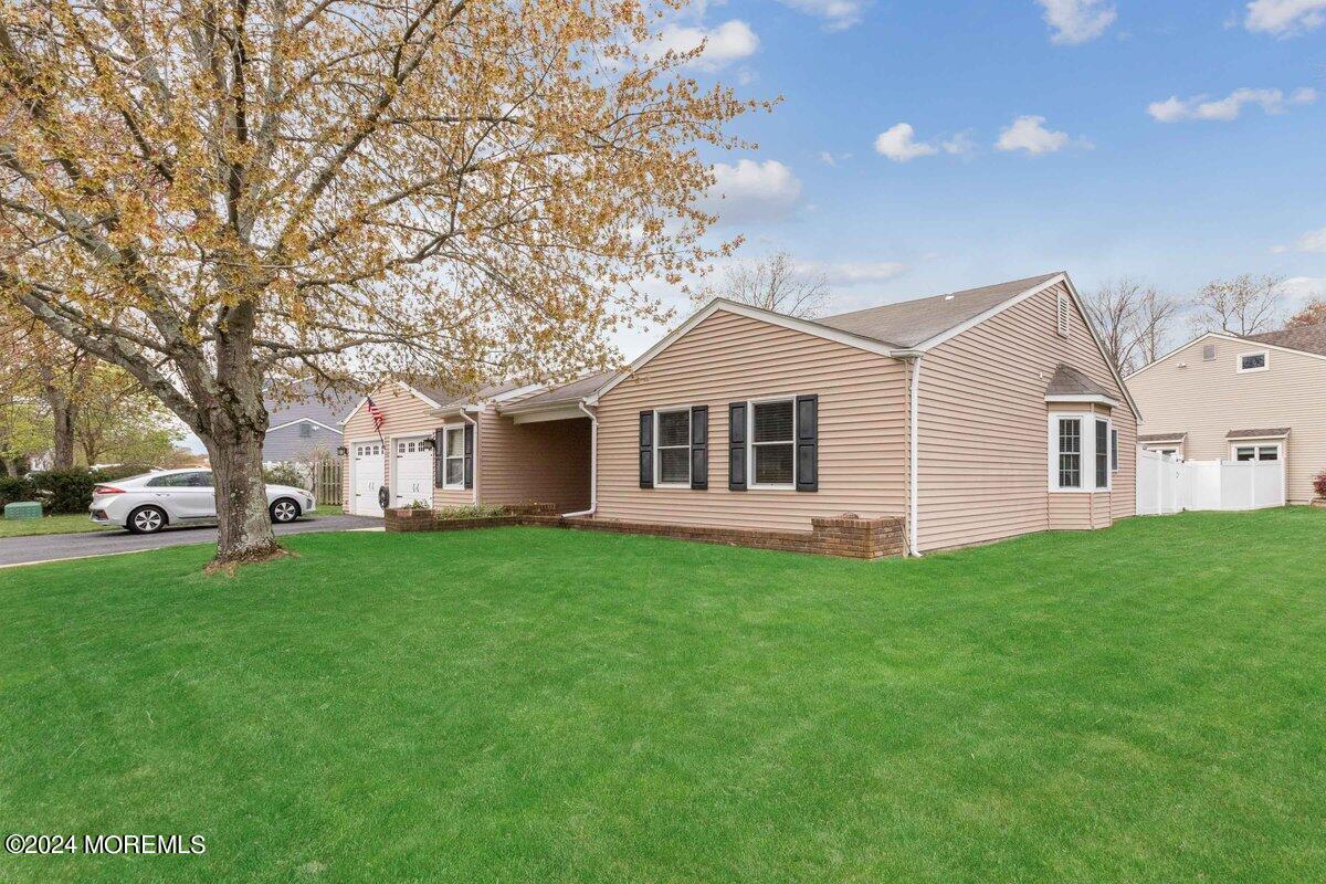 2 Concord Circle Howell, NJ 07731 - Photo 2 of 24 a view of a yard in front of a house with large trees