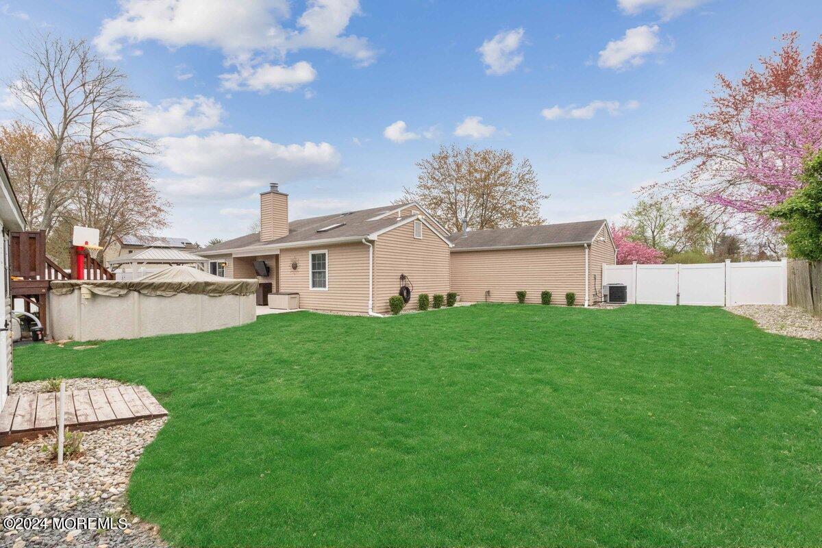 2 Concord Circle Howell, NJ 07731 - Photo 24 of 24 a view of a white house next to a yard and a large tree