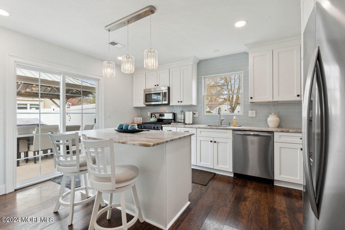 2 Concord Circle Howell, NJ 07731 - Photo 9 of 24 a kitchen with a sink cabinets and wooden floor