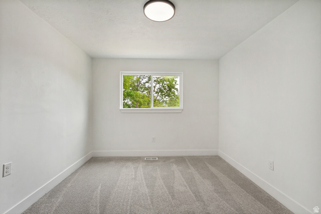 62 South Clark Lane Elk Ridge, UT 84651 - Photo 14 of 30 Neutral-toned 2nd bedroom featuring a single window, recessed lighting, and gray carpeting