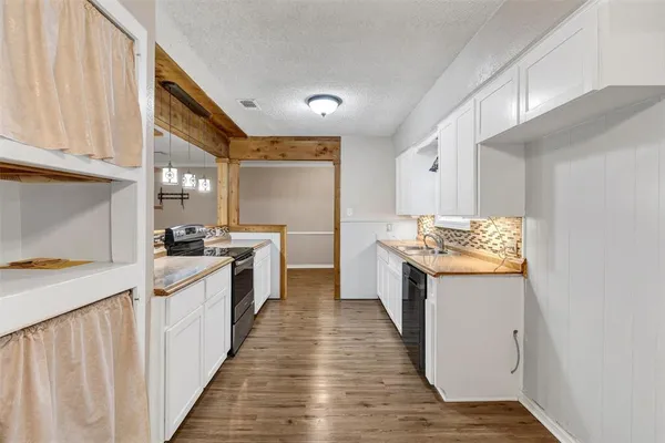 a kitchen with stainless steel appliances granite countertop a stove and a sink