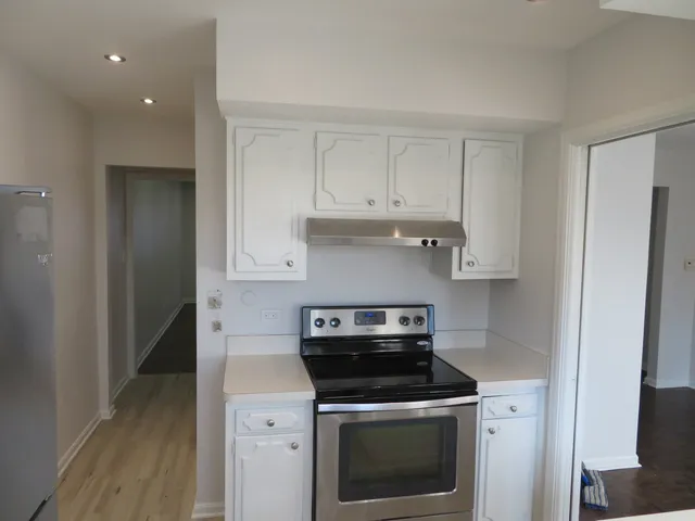 a kitchen with a stove and a refrigerator