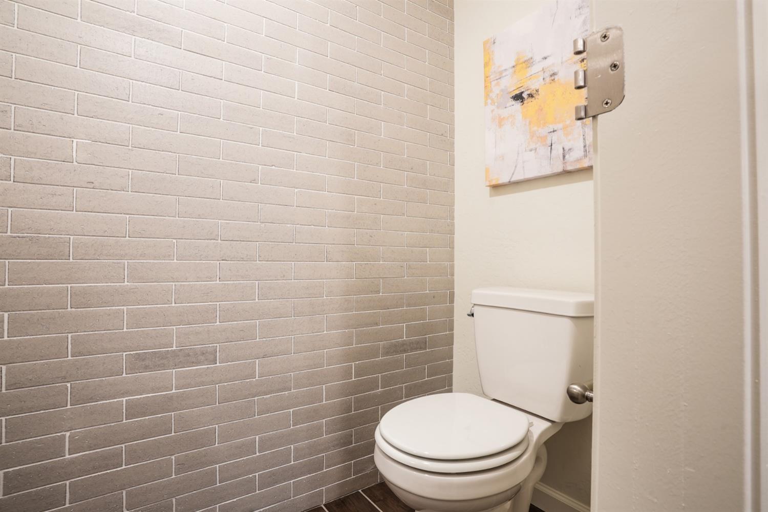 2329 North Raleigh Drive Fresno, CA 93727 - Photo 12 of 25 a white toilet sitting next to a white wall