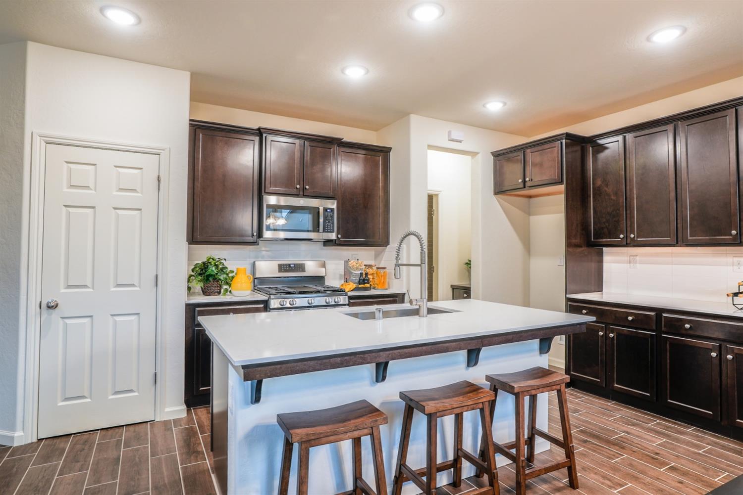 2329 North Raleigh Drive Fresno, CA 93727 - Photo 8 of 25 a kitchen with a sink cabinets and wooden floor