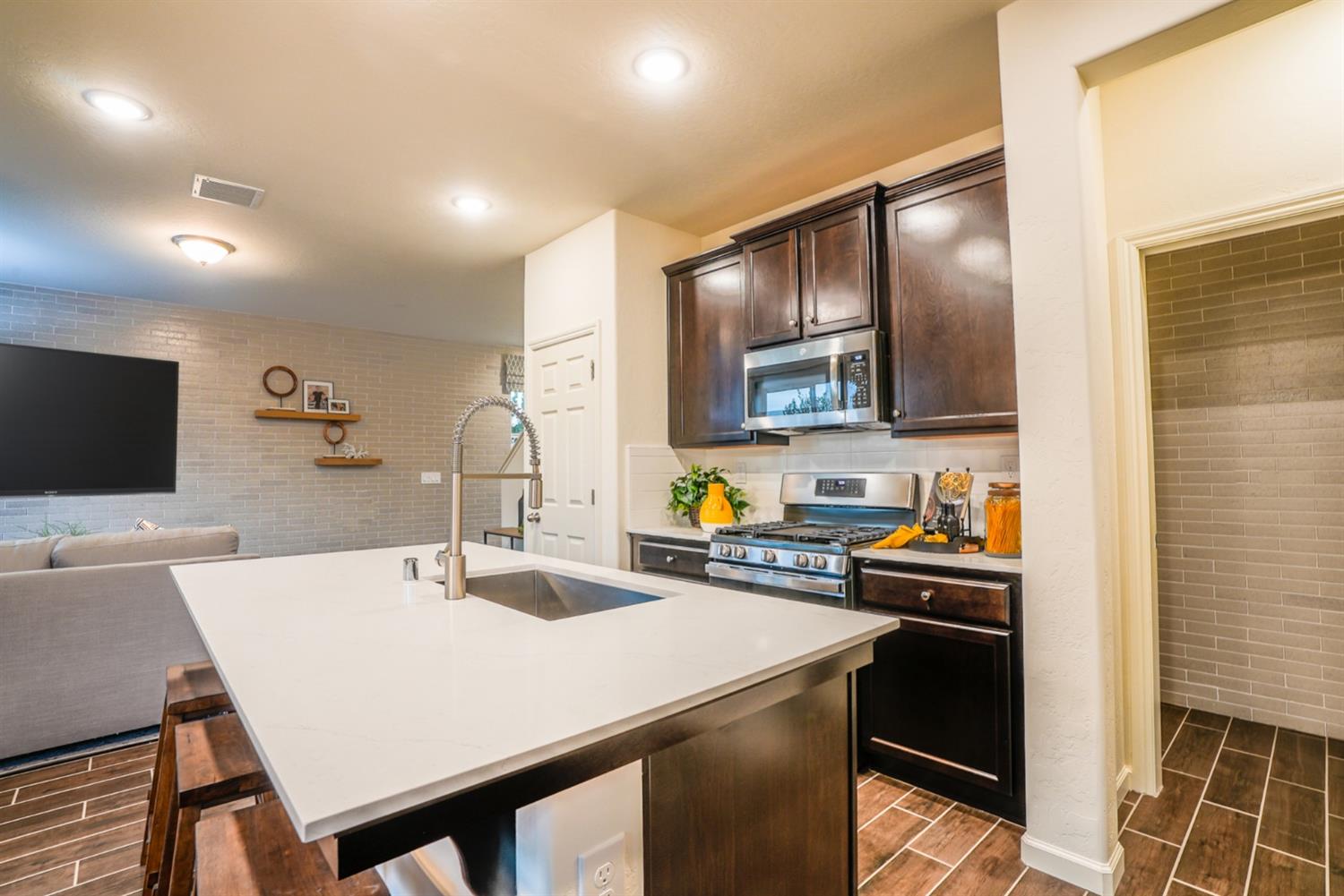 2329 North Raleigh Drive Fresno, CA 93727 - Photo 10 of 25 a kitchen with a sink a stove a refrigerator and island