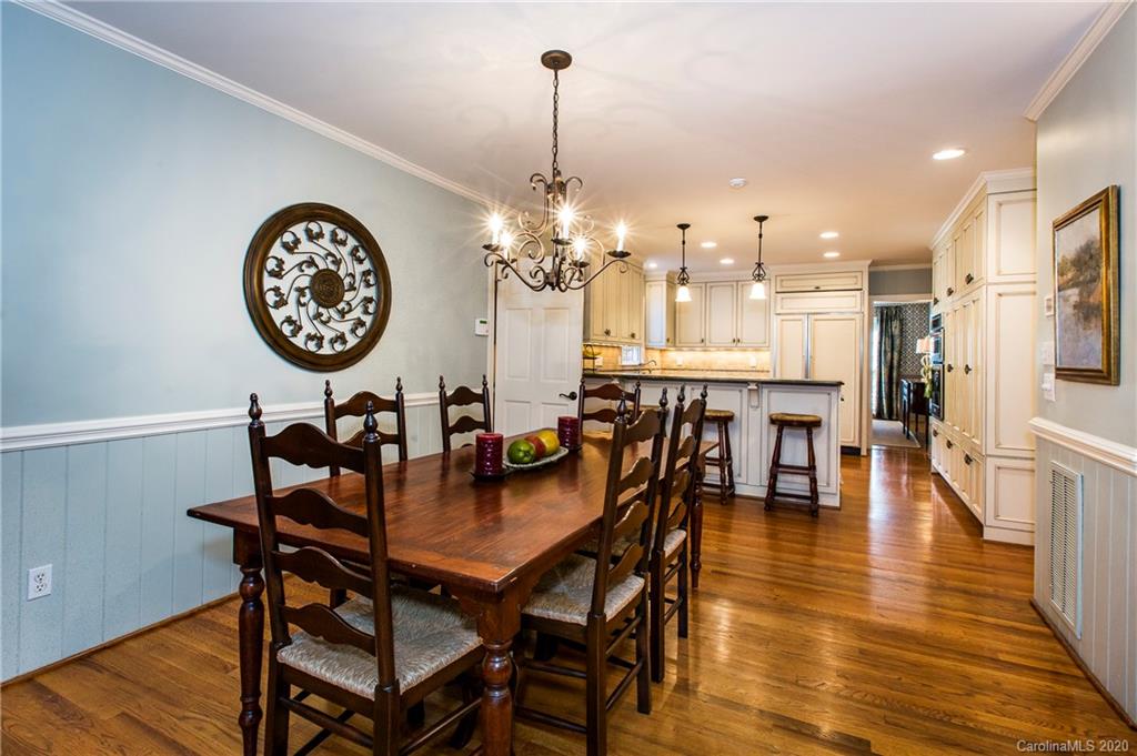 2930 Wheelock Road Charlotte, NC 28211 - Photo 18 of 48 a view of a dining room and livingroom with furniture wooden floor a rug a painting and a chandelier