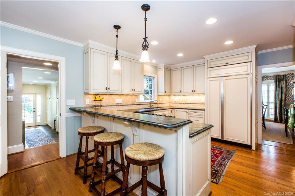 2930 Wheelock Road Charlotte, NC 28211 - Photo 24 of 48 a kitchen with stainless steel appliances granite countertop a stove a sink and a refrigerator