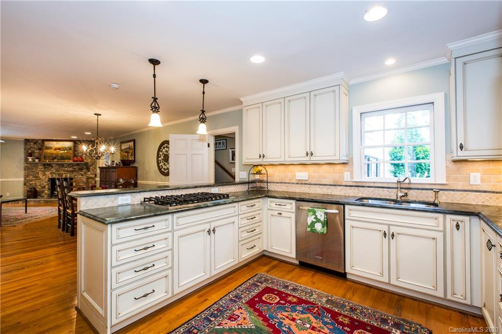 2930 Wheelock Road Charlotte, NC 28211 - Photo 25 of 48 a large kitchen with granite countertop a sink and cabinets