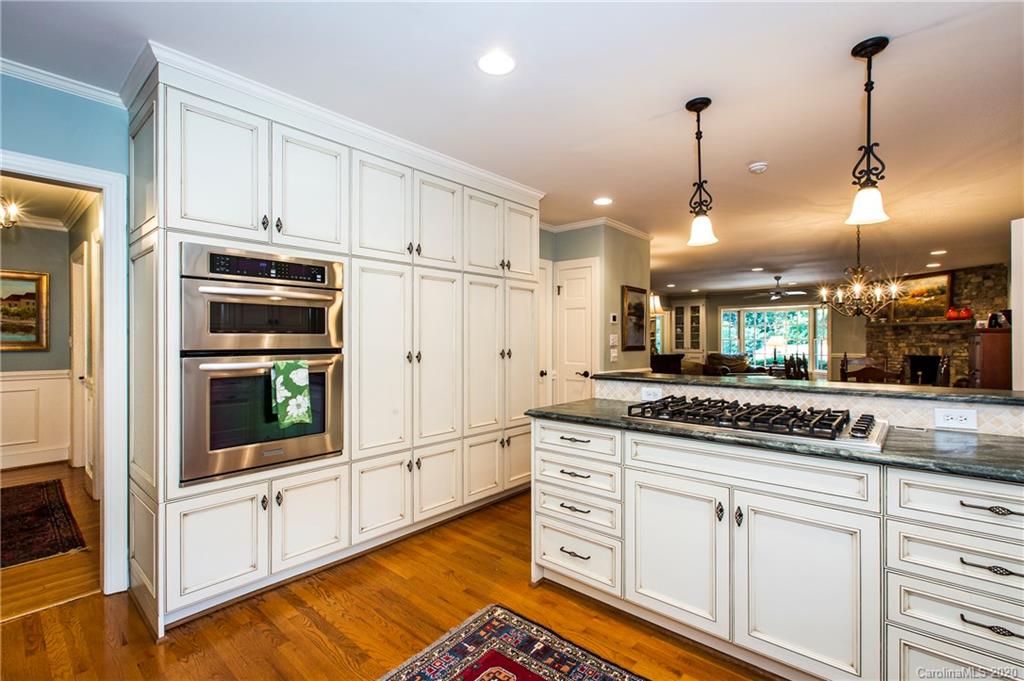 2930 Wheelock Road Charlotte, NC 28211 - Photo 26 of 48 a kitchen with stainless steel appliances granite countertop a stove a sink and a refrigerator
