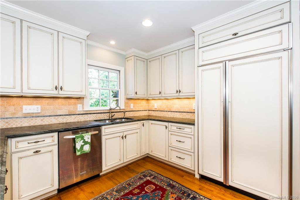 2930 Wheelock Road Charlotte, NC 28211 - Photo 27 of 48 a kitchen with stainless steel appliances granite countertop a sink and cabinets with wooden floor