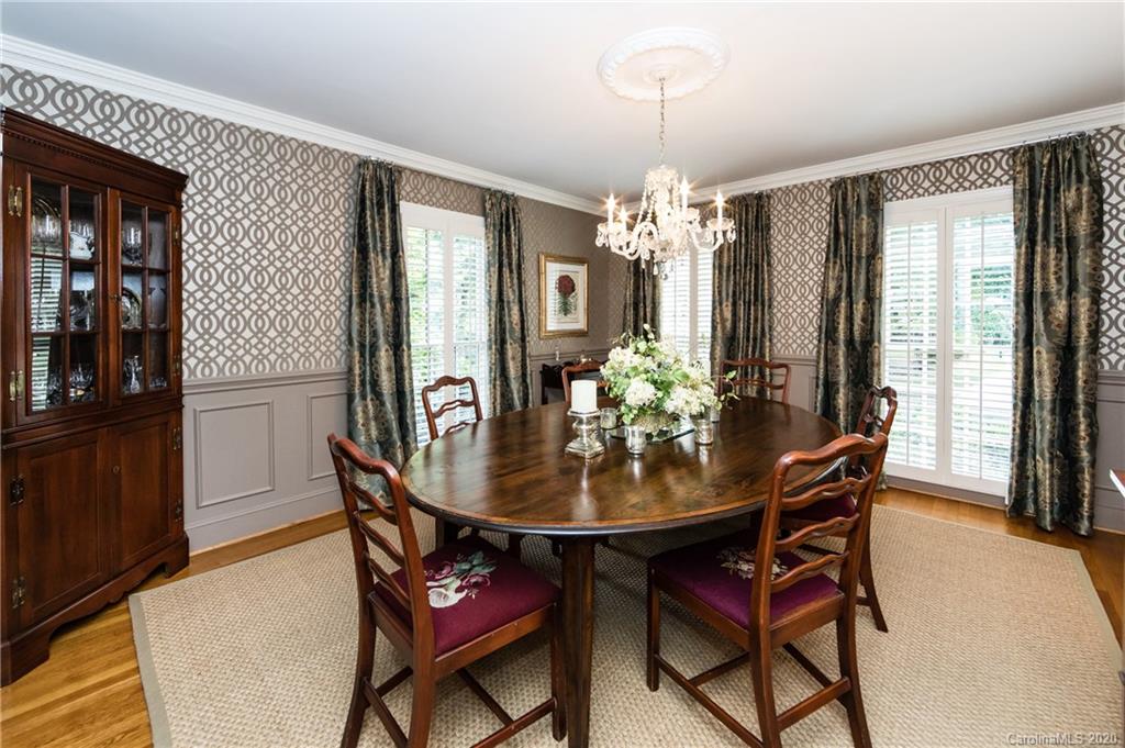 2930 Wheelock Road Charlotte, NC 28211 - Photo 29 of 48 a dining room with furniture a chandelier and wooden floor
