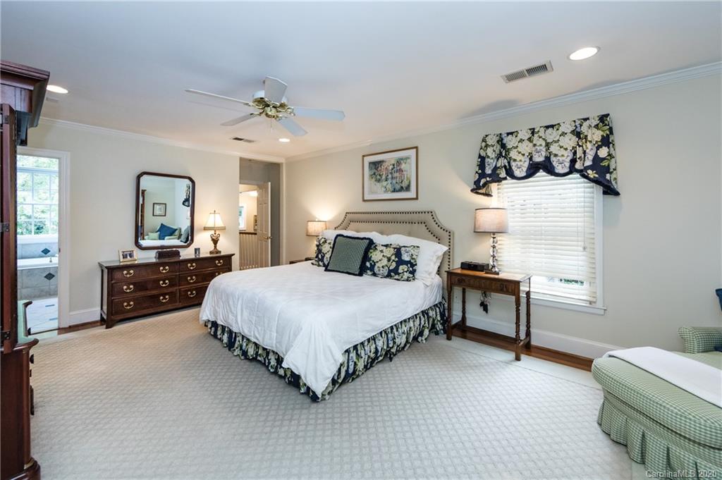 2930 Wheelock Road Charlotte, NC 28211 - Photo 31 of 48 a spacious bedroom with a bed mirror and window