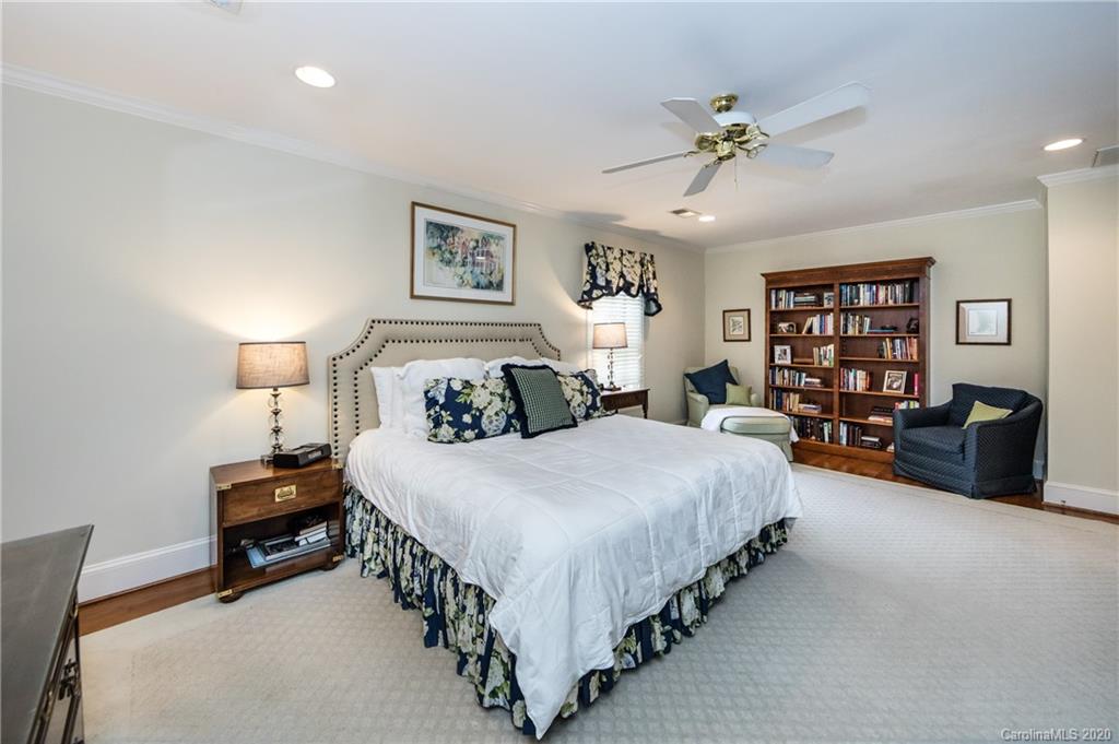 2930 Wheelock Road Charlotte, NC 28211 - Photo 32 of 48 a spacious bedroom with a bed a couch and a bookshelf