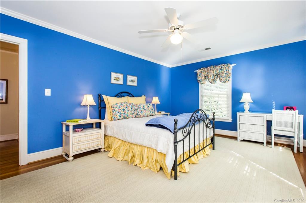 2930 Wheelock Road Charlotte, NC 28211 - Photo 35 of 48 a bedroom with a bed and a chandelier