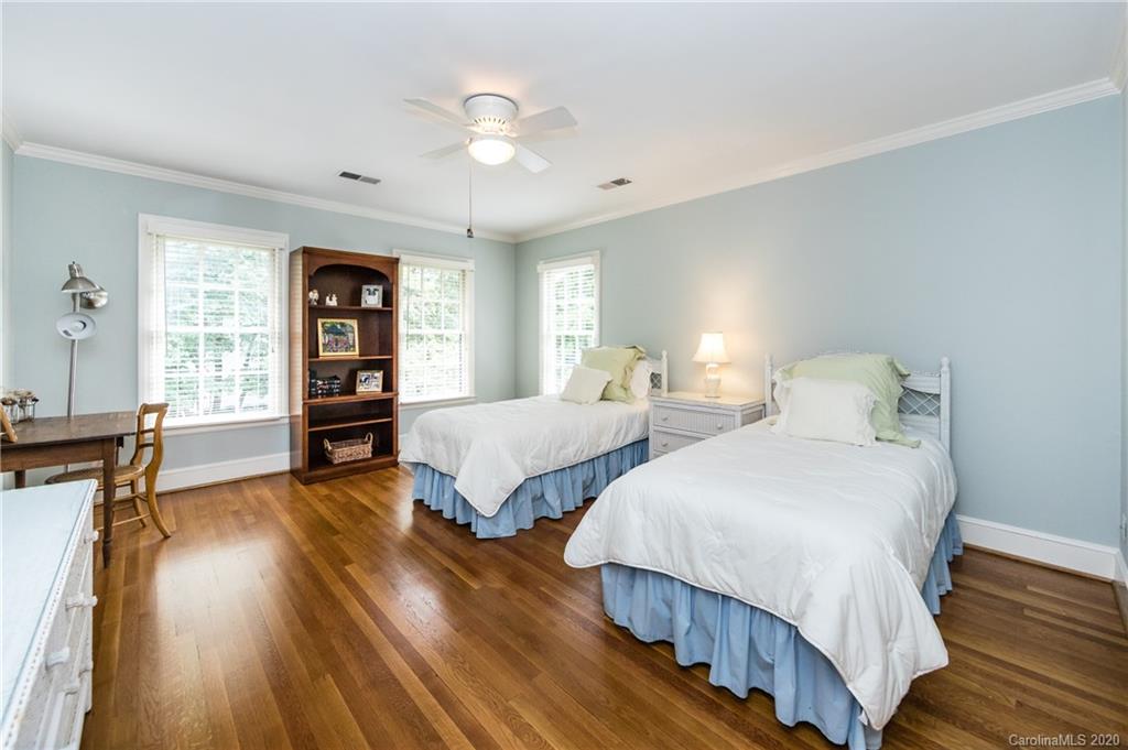 2930 Wheelock Road Charlotte, NC 28211 - Photo 36 of 48 a bedroom with two beds and a bookshelf