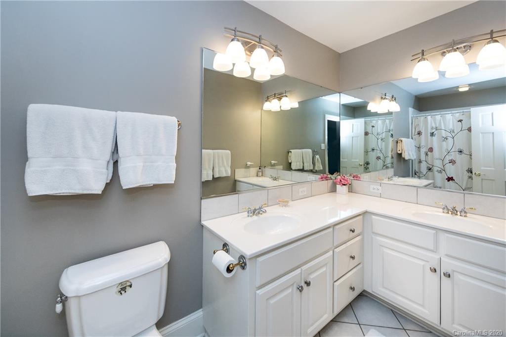 2930 Wheelock Road Charlotte, NC 28211 - Photo 37 of 48 a bathroom with a double vanity sink and a toilet