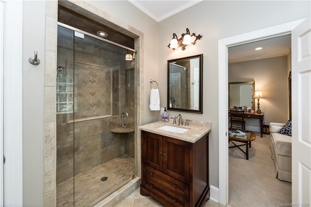 2930 Wheelock Road Charlotte, NC 28211 - Photo 41 of 48 a bathroom with a shower a mirror and a sink