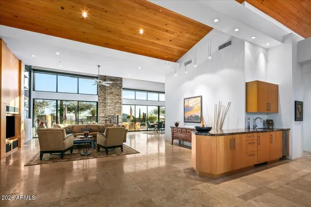 a dining room with stainless steel appliances kitchen island granite countertop a table and chairs