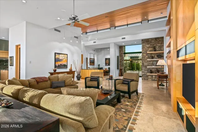 a dining room with furniture and a floor to ceiling window