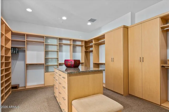 a living room with stainless steel appliances furniture and a large window
