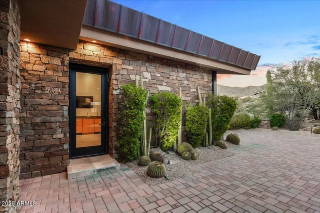 a view of a patio with a table chairs and a grill