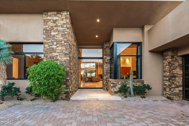 a living room with furniture ceiling fan and a large window