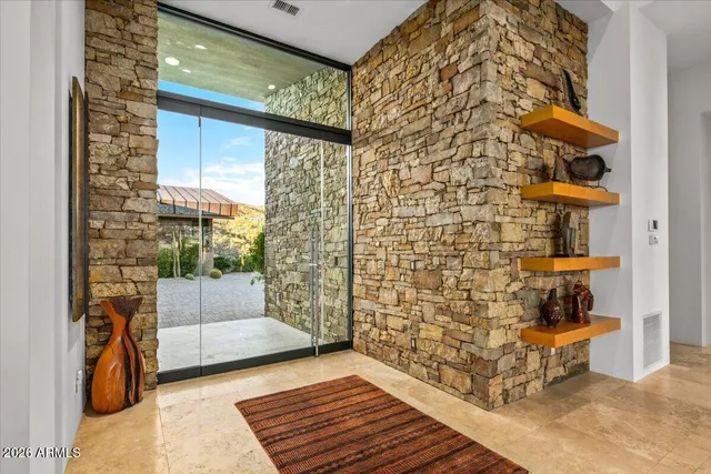 a living room with fireplace furniture and a large window