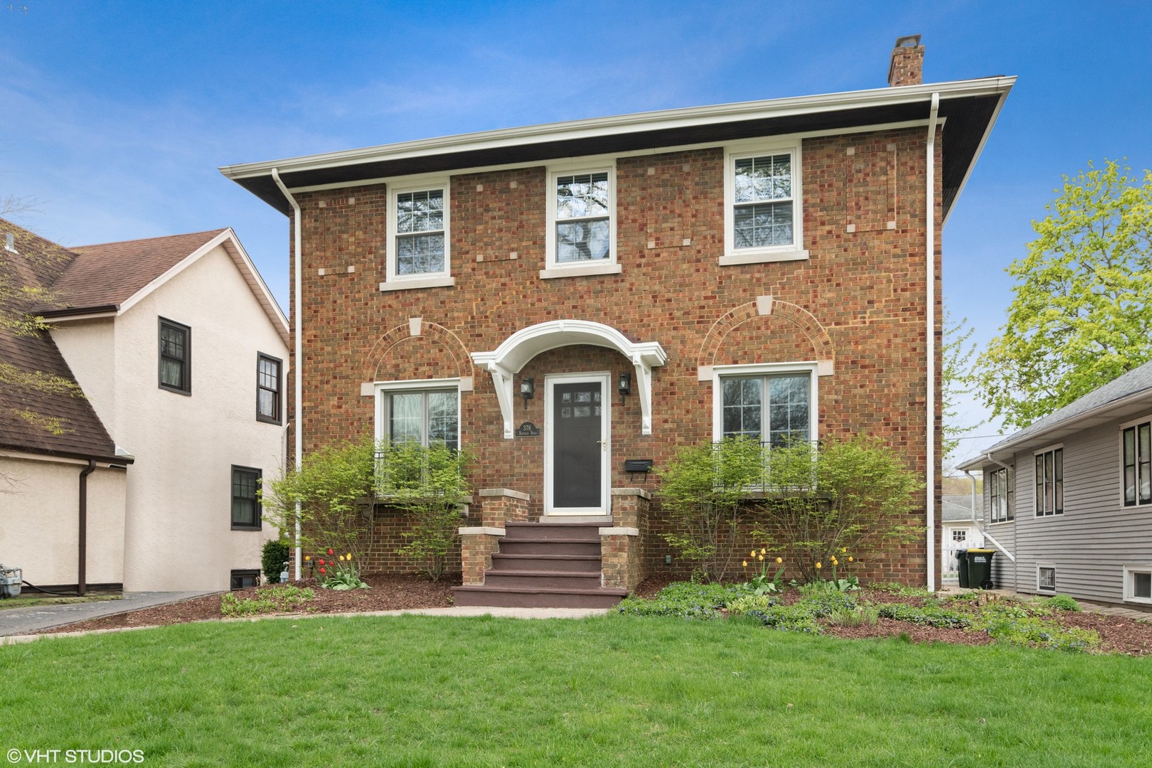 376 Bartram Road Riverside, IL 60546 - Photo 1 of 15 a front view of a house with a garden