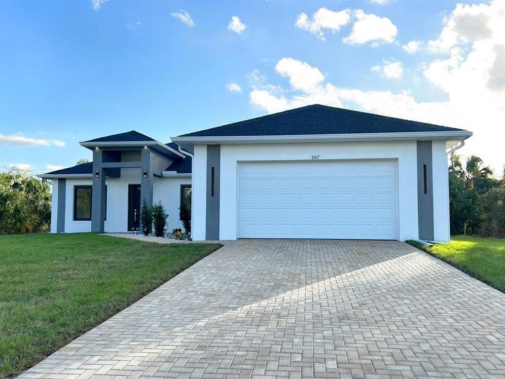 267 Santa Marta Street Port Charlotte, FL 33954 - Photo 1 of 13 a front view of a house with a yard and garage