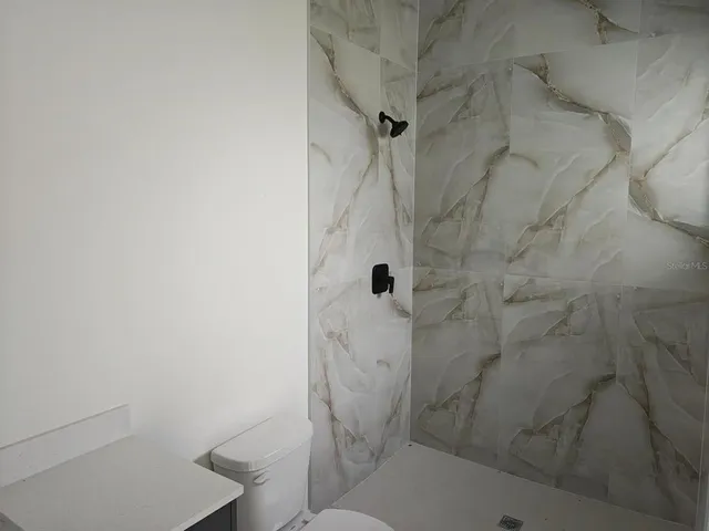 a bathroom with a shower and toilet