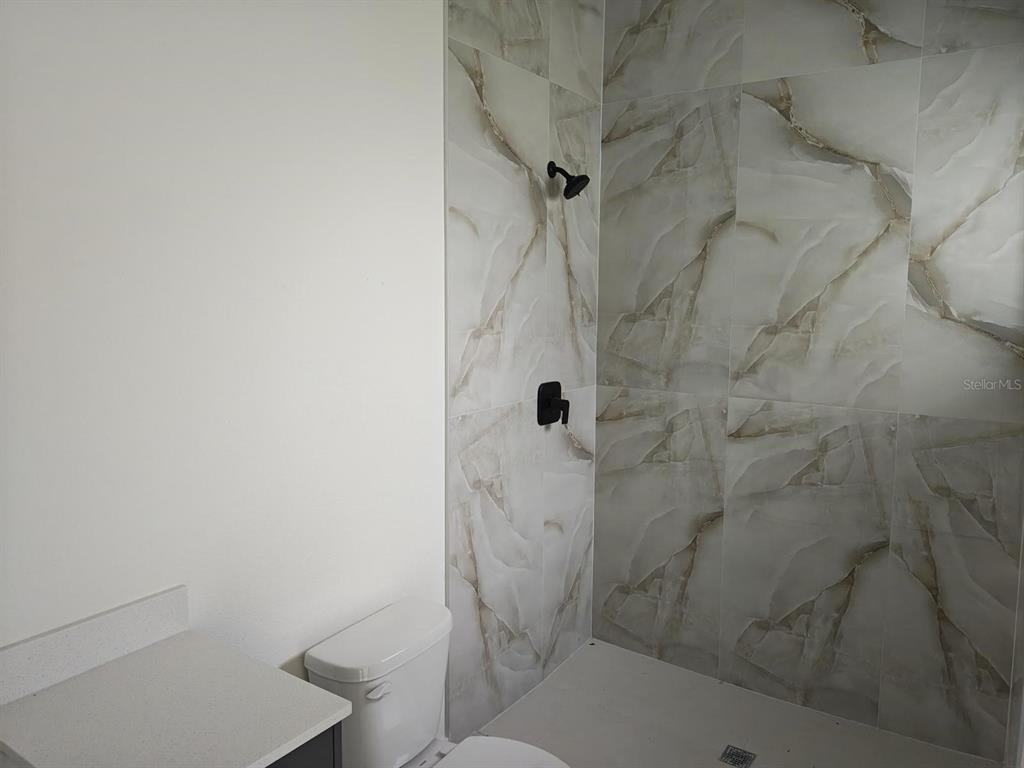 267 Santa Marta Street Port Charlotte, FL 33954 - Photo 6 of 13 a bathroom with a shower and toilet