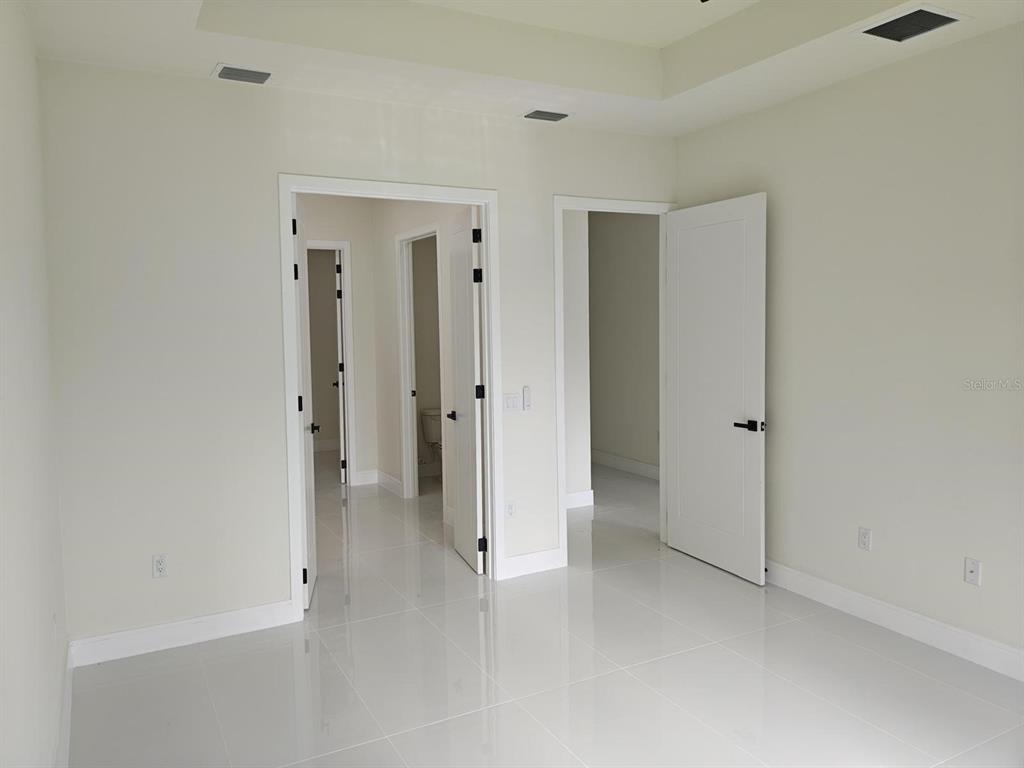 267 Santa Marta Street Port Charlotte, FL 33954 - Photo 9 of 13 wooden floor and closet in a room